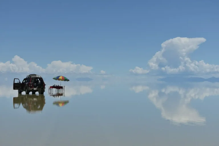 Picnic table and 4x4 on the flooded Salar de Uyuni during the mirror season