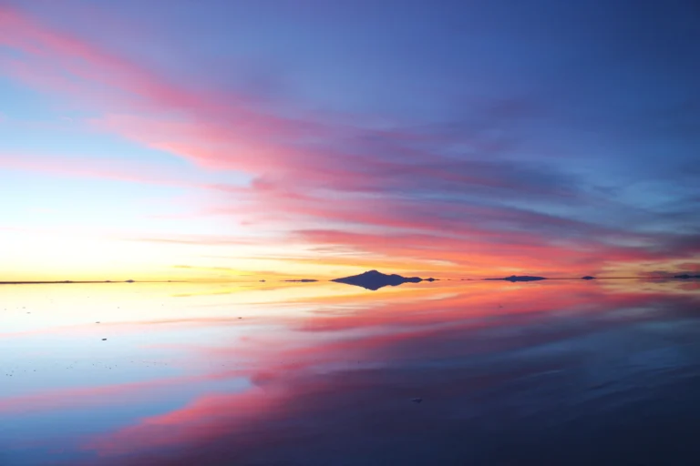 Pink sunset reflected on the flooded Salar de Uyuni