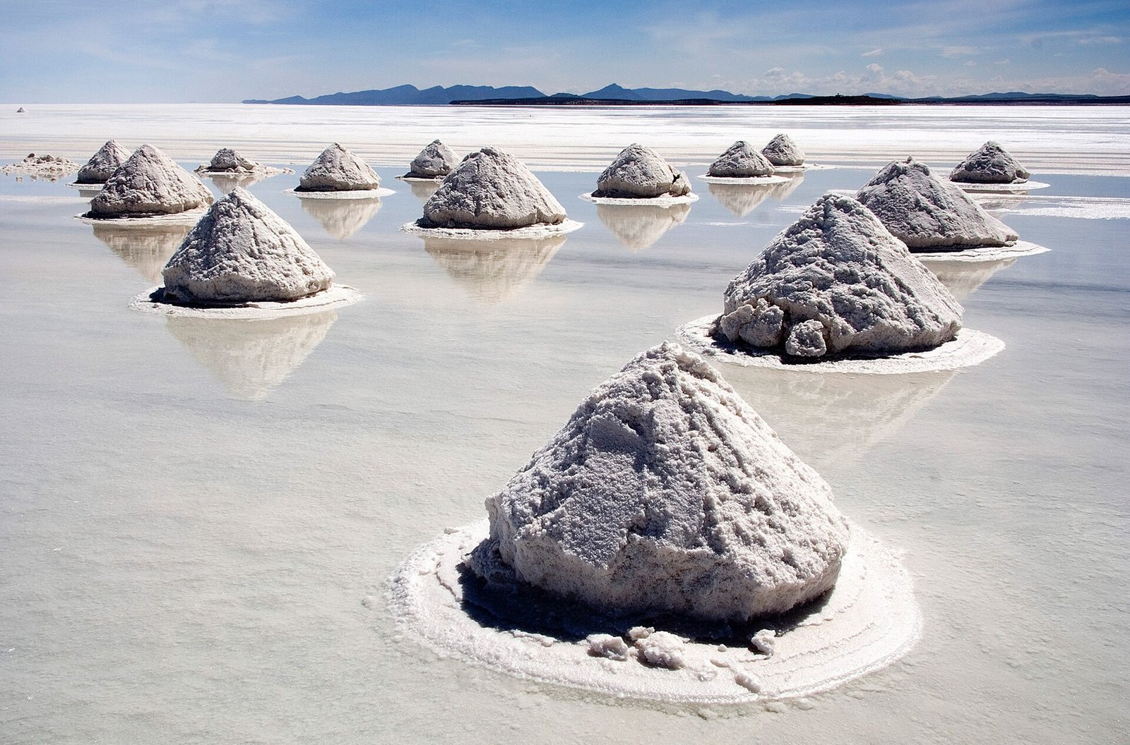 Piles of salt drying on the Salar de Uyuni near Colchani, a stop on Uyuni train cemetery day tours